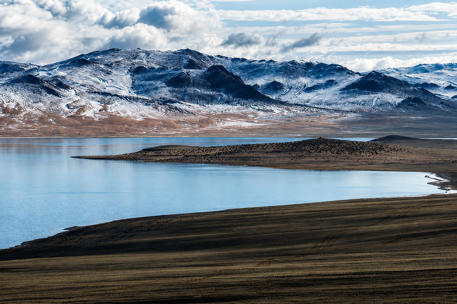 Snow-capped mountains and lake in the Mongolian countryside